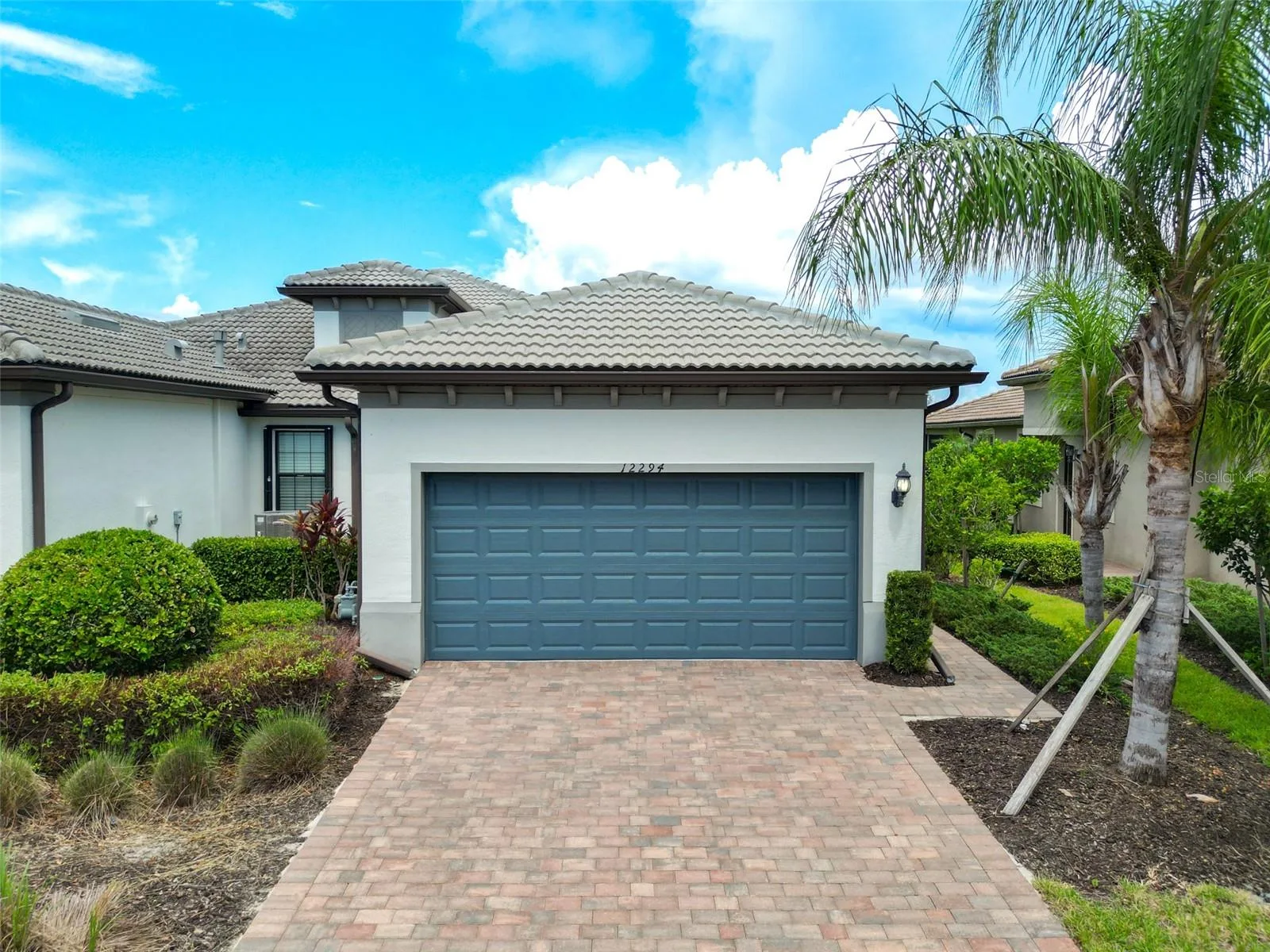Front of home. Long driveway and two car garage.