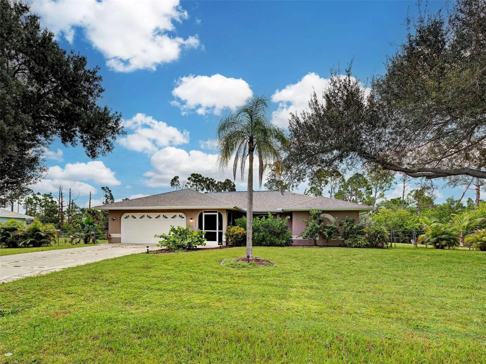 Attractive Florida-style home with mature landscaping. Great curb appeal.